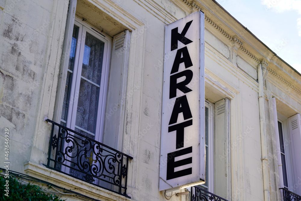 Karate sign text above a dojo wall building Karate sign text above a dojo wall building