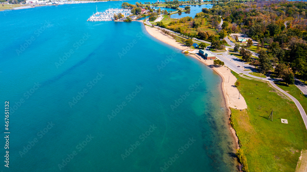 An aerial view of Belle Isle Beach with turquoise water so clear that it allows a view of the riverbed. 