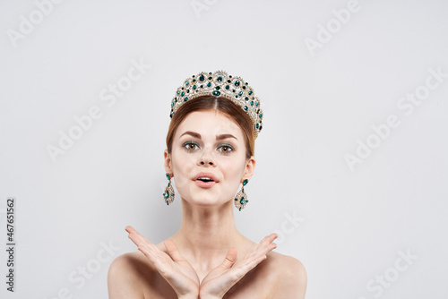 beautiful woman with a crown on her head makeup model isolated background