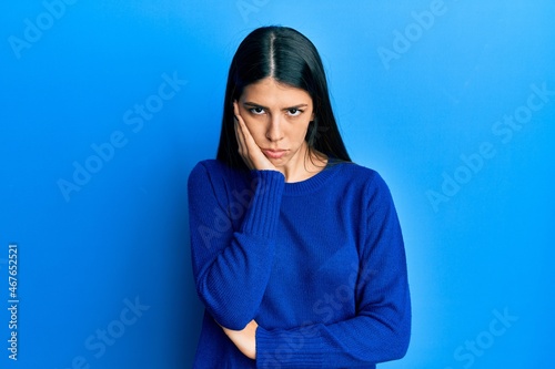 Young hispanic woman wearing casual clothes thinking looking tired and bored with depression problems with crossed arms. © Krakenimages.com