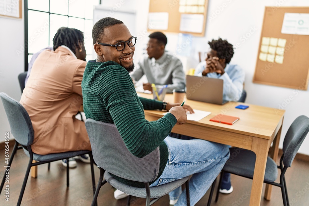 Group of young african american business workers smiling happy working at the office. Group of young african american business workers smiling happy working at the office.