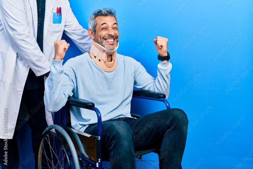 Handsome middle age man with grey hair on wheelchair wearing cervical collar celebrating surprised and amazed for success with arms raised and open eyes. winner concept.