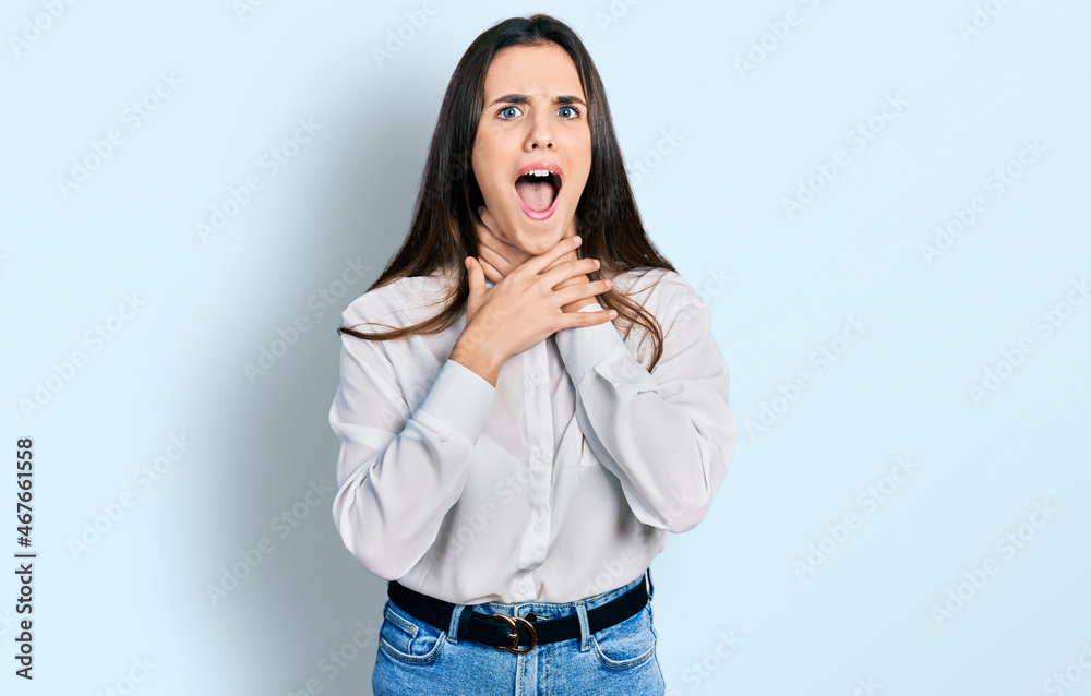 Young brunette teenager wearing business white shirt shouting and suffocate because painful strangle. health problem. asphyxiate and suicide concept. Young brunette teenager wearing business white shirt shouting and suffocate because painful strangle. health problem. asphyxiate and suicide concept.