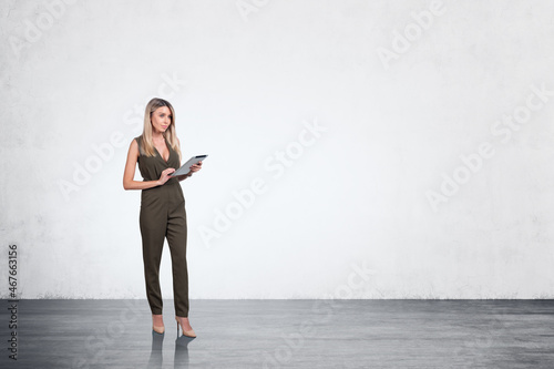 Businesswoman in jumpsuit with table in hands working  mockup