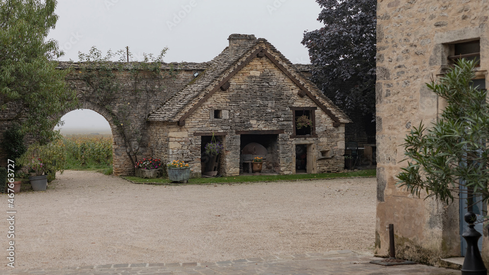 Looking through a gateway at a stone built shed