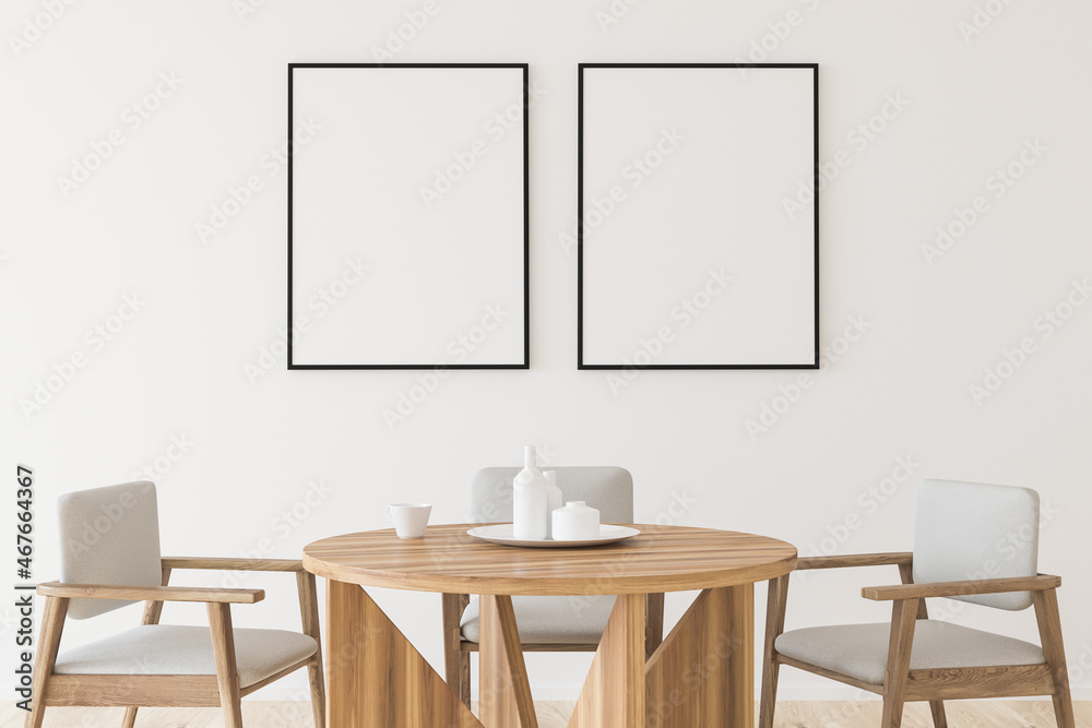Two empty canvases on wall in white dining room Two empty canvases on wall in white dining room