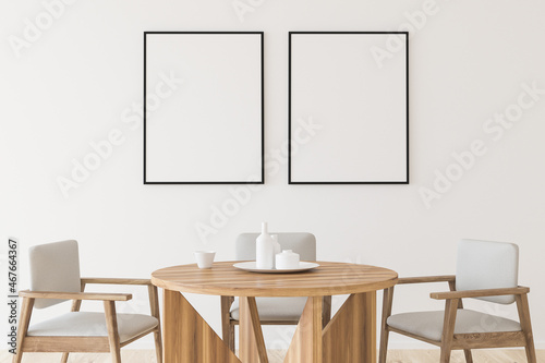 Two empty canvases on wall in white dining room © ImageFlow