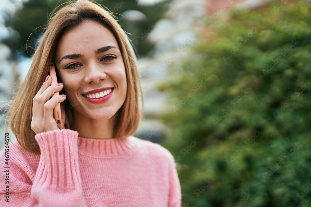Young caucasian girl smiling happy talking on the smartphone at the city. Young caucasian girl smiling happy talking on the smartphone at the city.