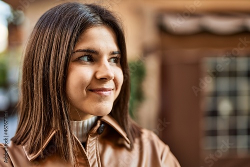 Young beautiful brunette woman smiling happy outdoors