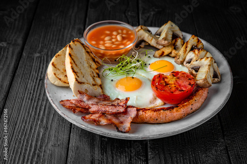 Classic English Breakfast of fried eggs  toast  cheese  bacon  tomatoes. Healthy Nutritious Dish with food top view.