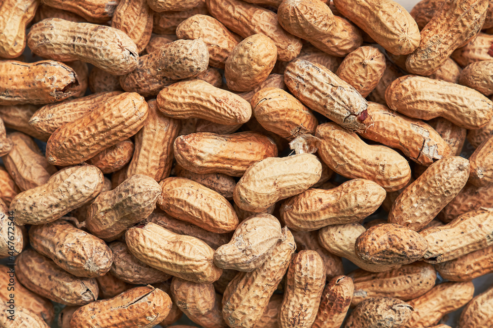 Healthy roasted unpeeled peanuts. Brown nuts texture Healthy roasted unpeeled peanuts. Brown nuts texture