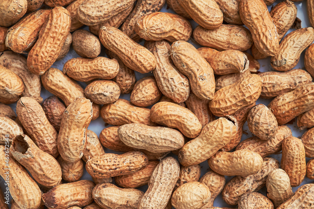 Healthy roasted unpeeled peanuts. Brown nuts texture