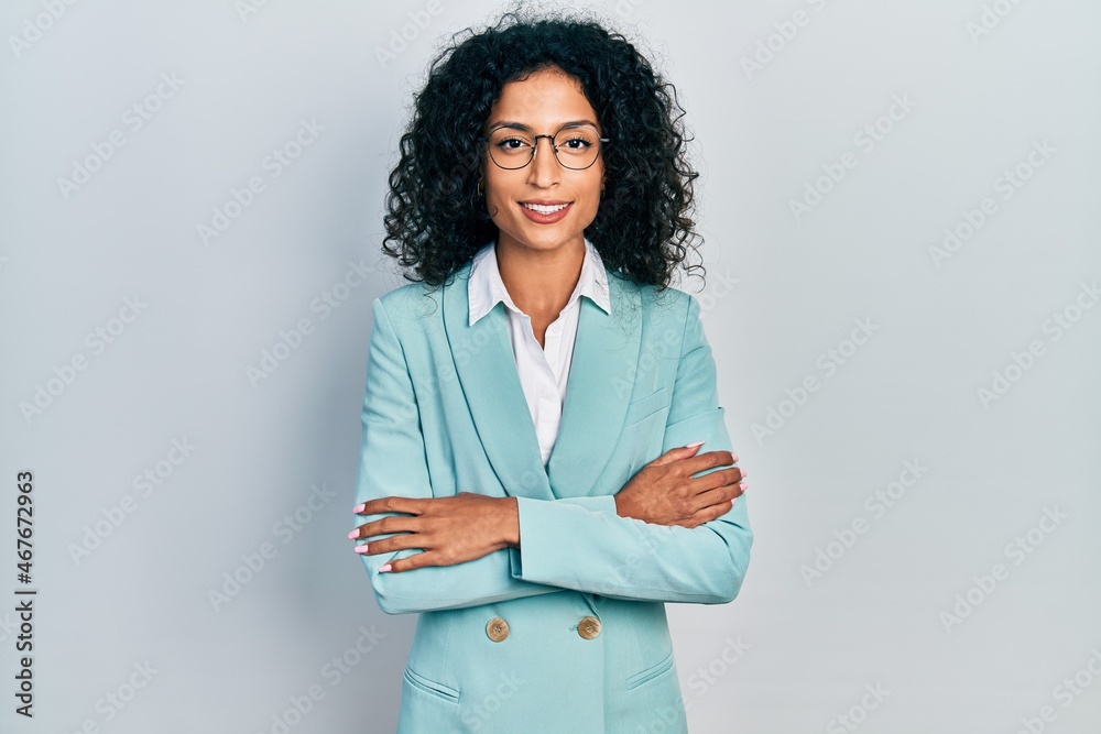 Φωτογραφία Young latin girl wearing business clothes and glasses happy face smiling with crossed arms looking at the camera