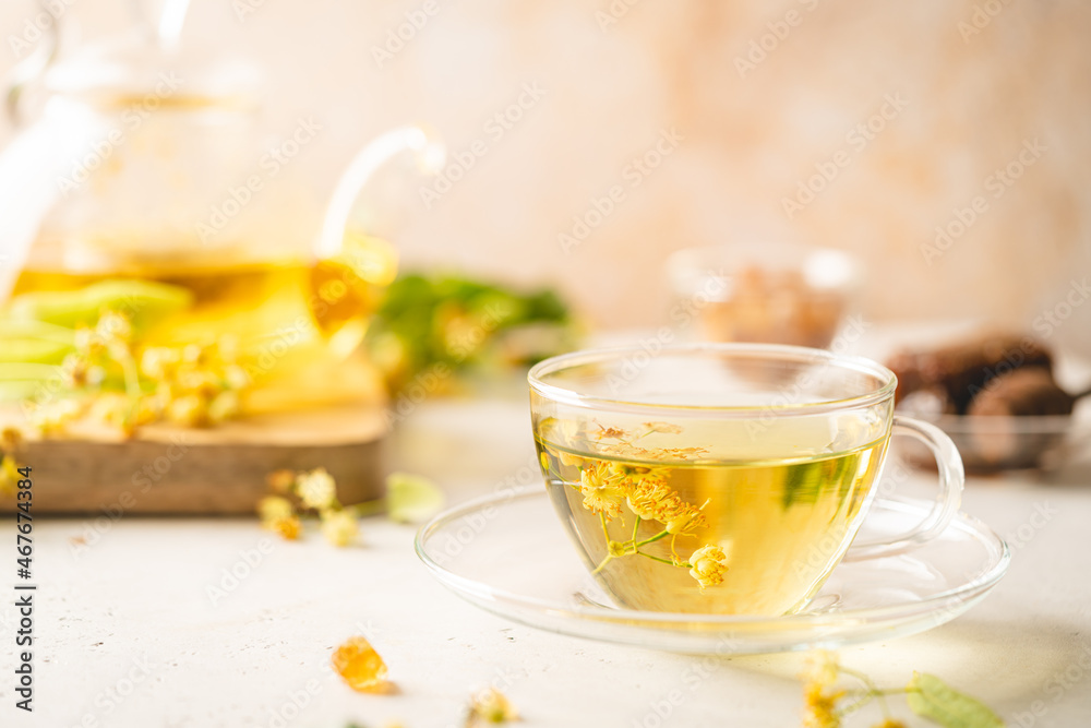 Cup of herbal tea with linden flowers on white background Cup of herbal tea with linden flowers on white background
