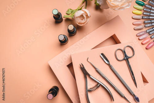 Set of manicure tools and accessories for hardware manicure, nail polish and design on a pink background. Flat lay, top view with Copy space.