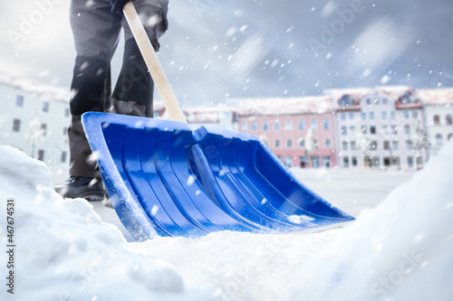 Snow removal with a snow shovel in winter photo