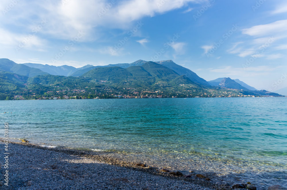 Panorama of the gorgeous Lake Garda surrounded by mountains, Italy.