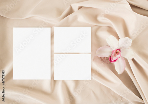 Wedding invitation mockup with lily and on the nude background
