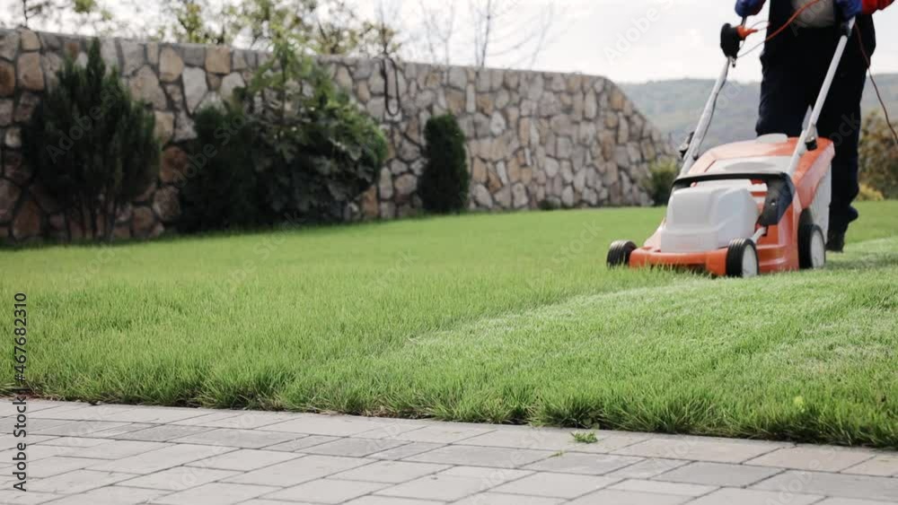 The process of mowing the lawn with lawn mower in autumn calm weather The process of mowing the lawn with lawn mower in autumn calm weather