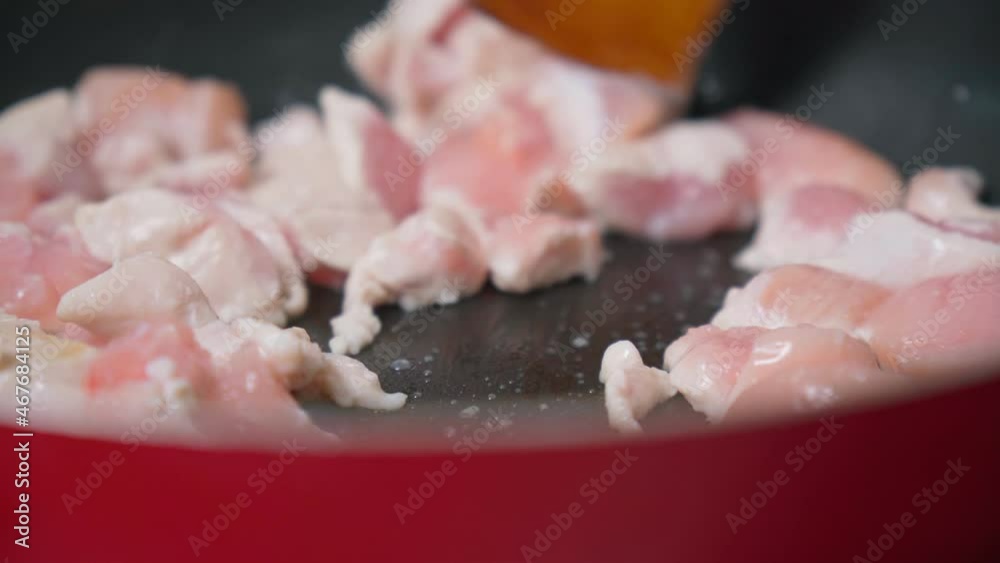 Cooking chicken fillet slices close-up in a frying pan. Cooking at home Cooking chicken fillet slices close-up in a frying pan. Cooking at home
