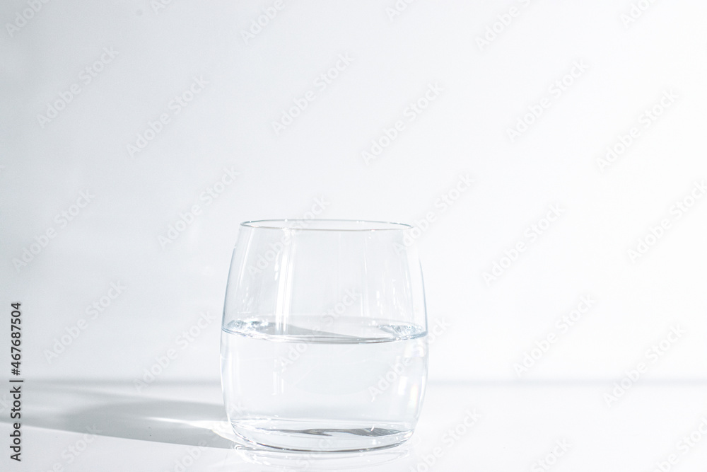 A glass of clean drinking water on a light background A glass of clean drinking water on a light background