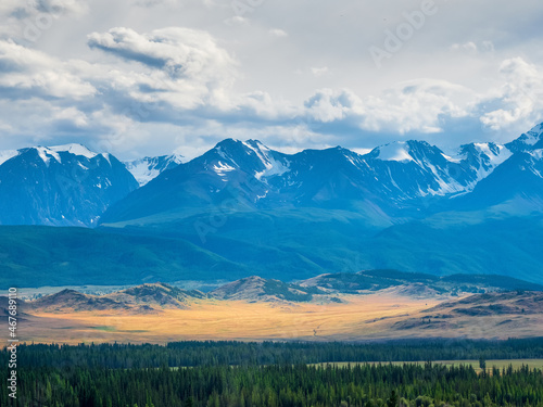 Atmospheric highland landscape of majestic nature. Spectacular view of giant mountains under cloudy sky. Huge mountain range at dramatically weather. Wonderful wild scenery. Scenic mountainscape.
