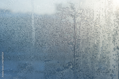 the street through the icy window is a pale blue urban background