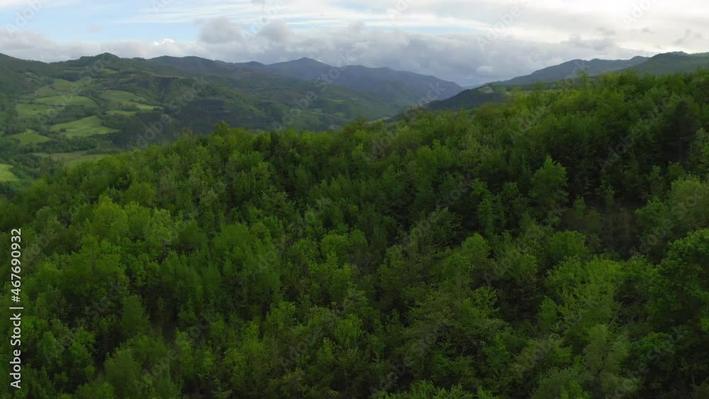 Aerial: Scenic Shot Of Hills Against Cloudy Sky, Drone Flying Forward Over Green Trees - Apennine Mountains, Italy Aerial: Scenic Shot Of Hills Against Cloudy Sky, Drone Flying Forward Over Green Trees - Apennine Mountains, Italy