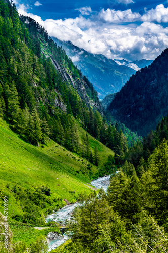 Clear Mountain River Flows Through Alpine Valley With Pine Forests In Deferegental And National Park Hohe Tauern In Tirol In Austria
