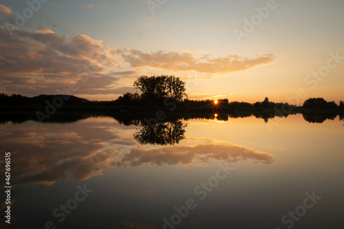 Reflection of the sunset and clouds in the lake © darekb22