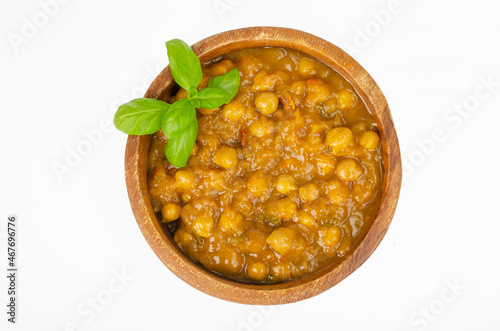 Chickpeas with curry sauce in wooden bowl. Studio Photo