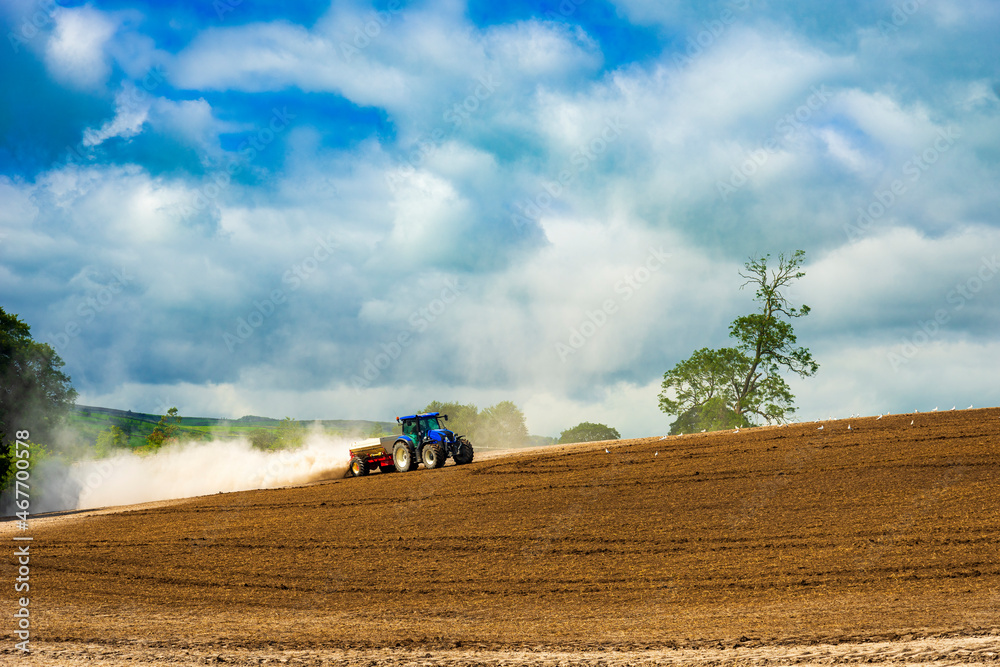 Naklejka premium Tractor ploughs a field on a Yorkshire farm