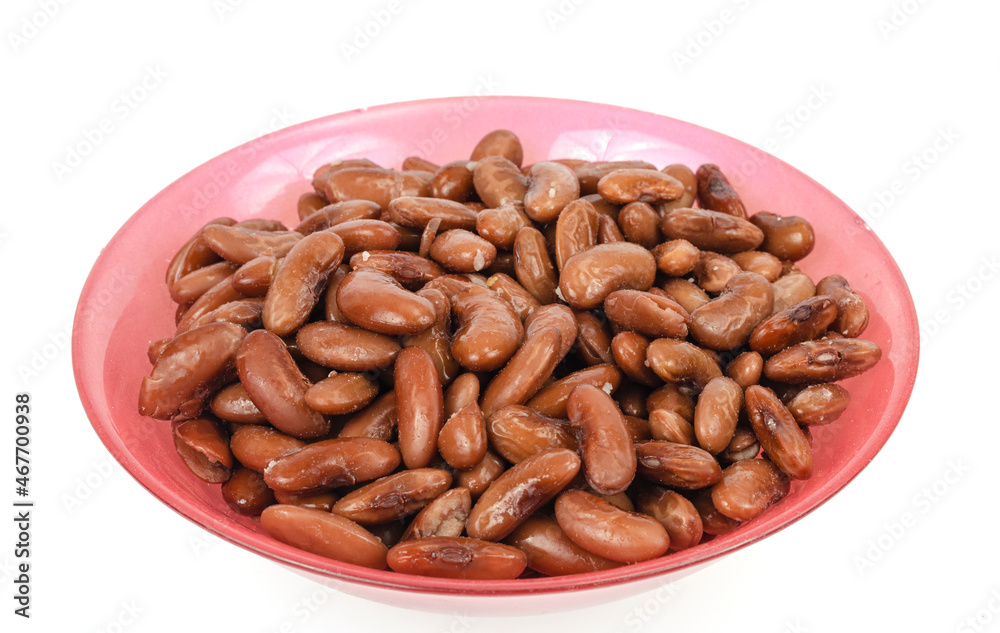 Tinned beans in red bowl on white background. Studio Photo