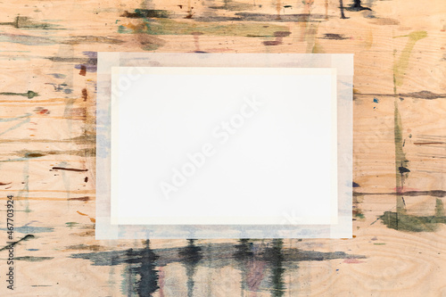 Fotografie blank white sheet of paper on stained wooden board prepared for drawing