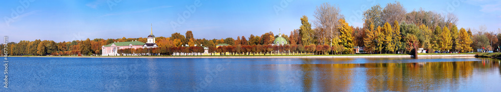 Panoramic wide angle view of pond reflections of historic Kuskovo buildings and sunny autumn park