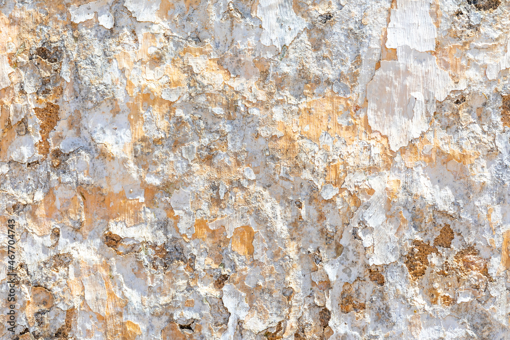 background of old plaster wall with peeling colors in white and orange background of old plaster wall with peeling colors in white and orange