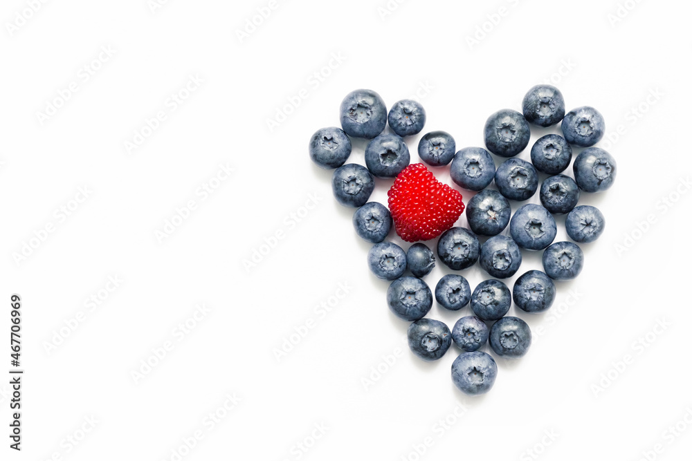 Delicious blueberries formed into a heart shape on white background. Delicious blueberries formed into a heart shape on white background.