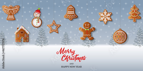 Merry christmas background with gingerbread cookies on snowy landscape background