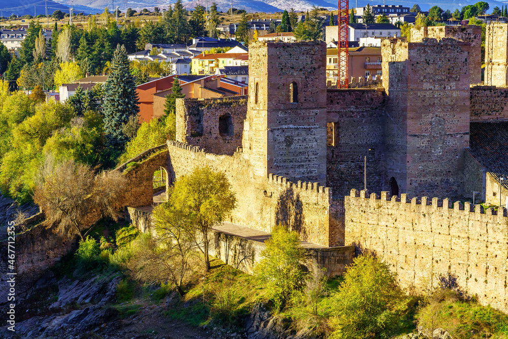 Medieval castle with its wall in an autumnal sunset. Buitrago del Lozoya, Madrid.