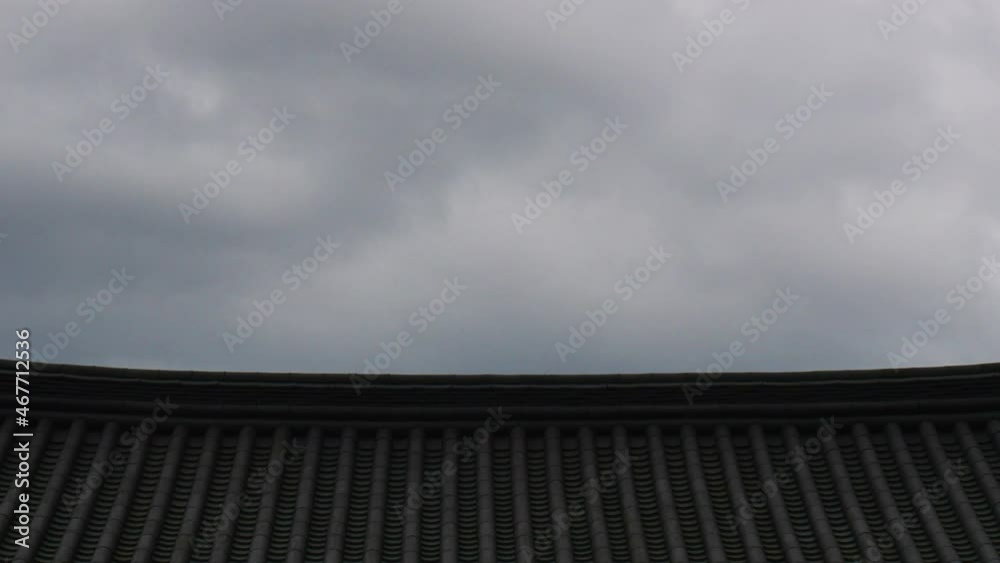 Clouds move over the traditional korean confucian school roof. Clouds move over the traditional korean confucian school roof.