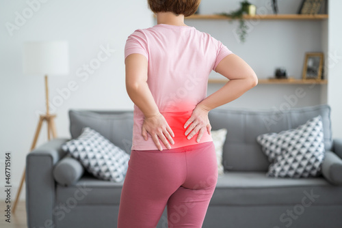 Back pain, kidney inflammation, woman suffering from backache at home