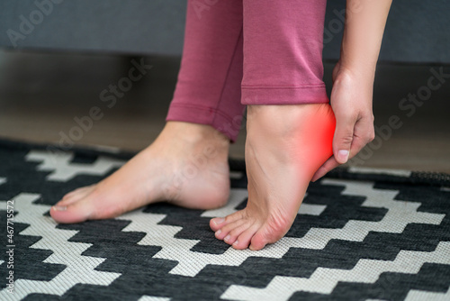 Plantar fasciitis, heel spur, foot pain, man suffering from feet ache at home photo