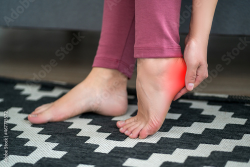 Plantar fasciitis, heel spur, foot pain, man suffering from feet ache at home