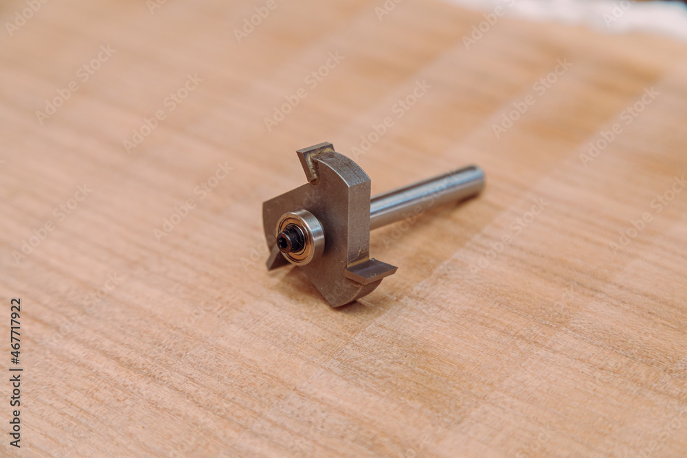 Steel router bit for milling cutter on a wooden table Steel router bit for milling cutter on a wooden table