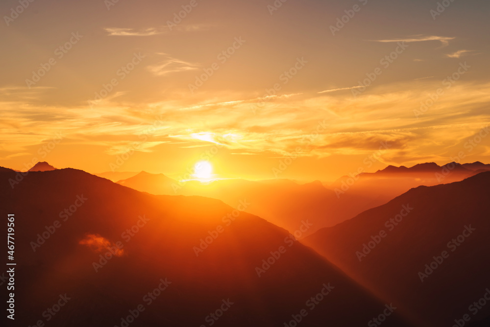 mountain landscape with mist at sunset
