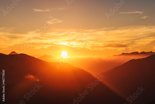 mountain landscape with mist at sunset