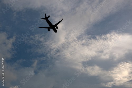 Airplane flying in the sky with clouds background