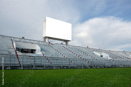 blank billboard in sport stadium with blue sky and clouds background