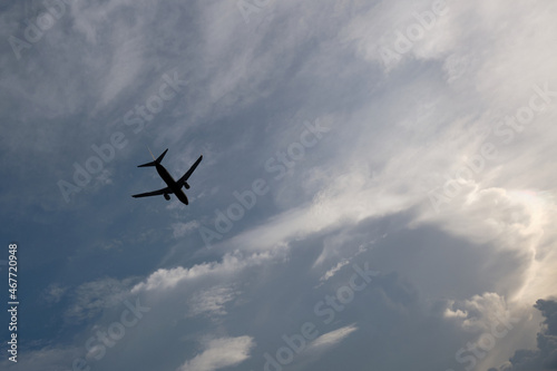 Airplane flying in the sky with clouds background © watink