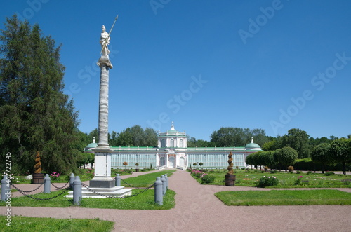Moscow, Russia - June 17, 2021: A column with a statue of Minerva in honor of the visits of Catherine II and a large stone greenhouse (1761-1763) in the Kuskovo Estate Museum